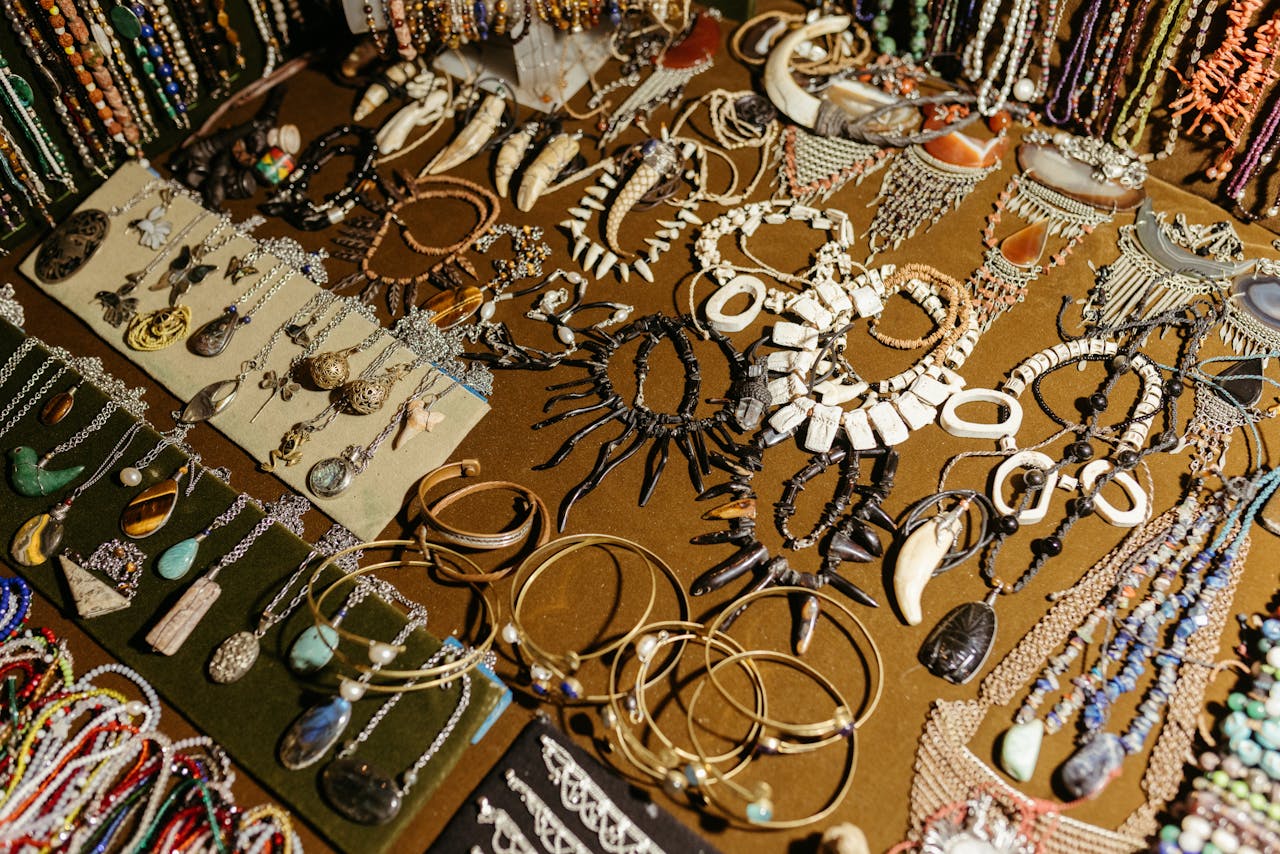 services-img A vibrant display of handcrafted jewelry including necklaces, bracelets, and earrings at a market stall.